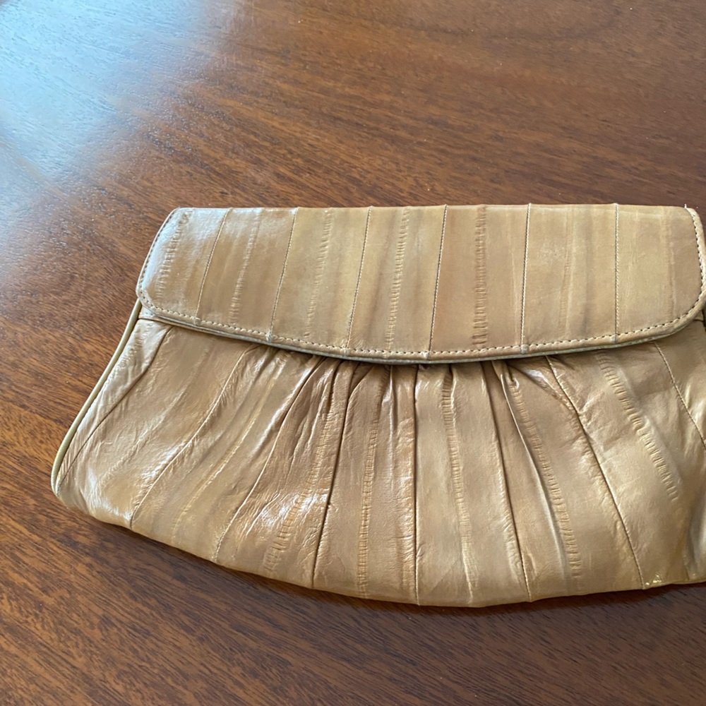 Lovely beige eel skin bag. The clutch style takes it from day to night.